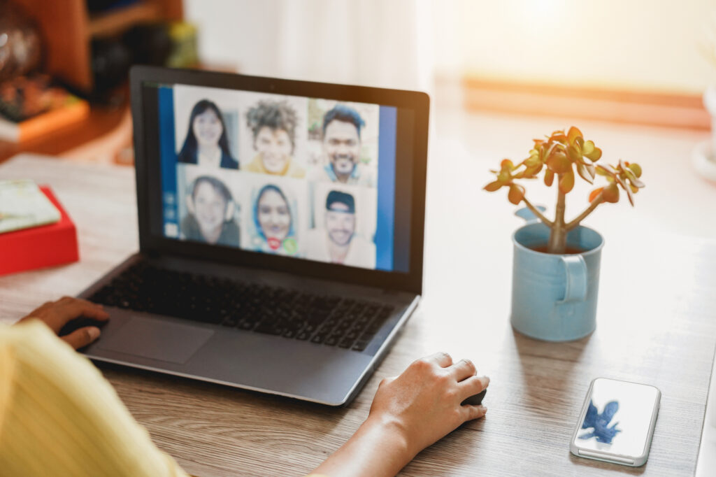 A remote healthcare administrative assistant using a laptop for a virtual meeting, providing background support to enhance the overall healthcare experience.