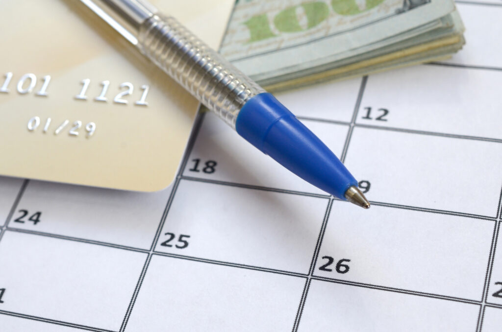 Calendar with credit card and dollar bills representing appeal deadlines and lost revenue from delayed prior authorization appeals