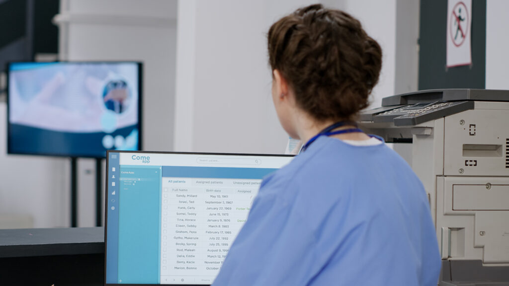 Medical administrative specialist reviewing surgical pre-authorization records and patient queues within EHR workflows