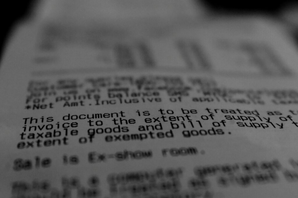 Close-up of printed billing document text, representing the revenue impact of denied and underpaid claims