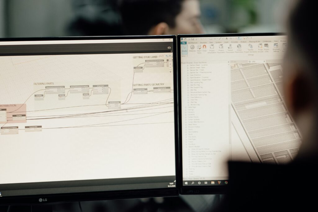 Dynamo visual script automating stud layers next to a Revit 3D model on a dual-monitor architecture workstation